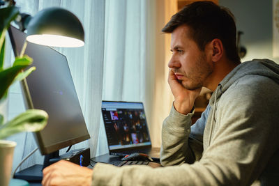 Young man using laptop at home