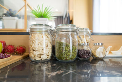 Close-up of fruits in glass jar on table