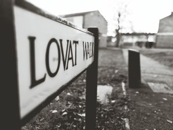 Close-up of road sign against sky