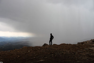 Silhouette of man standing on mountain