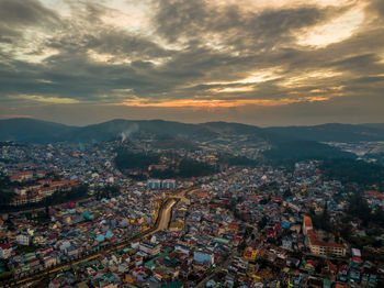 High angle shot of townscape against sky at sunset