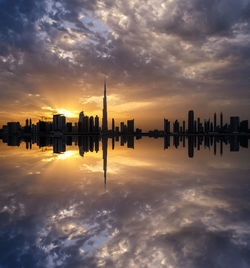 Silhouette buildings against sky during sunset