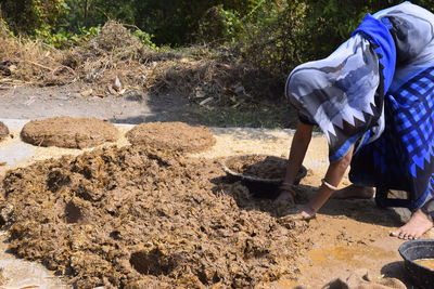 Man working in mud on field