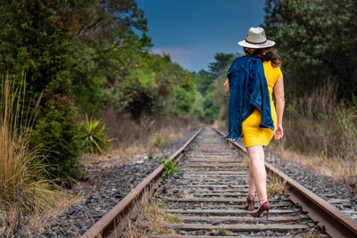 Man standing by railroad tracks