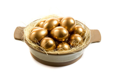 Close-up of eggs in container against white background