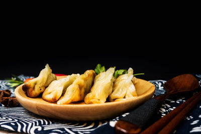 Food served in plate on table against black background