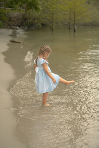 Rear view of boy on beach