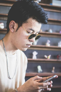 Close-up of young man using mobile phone