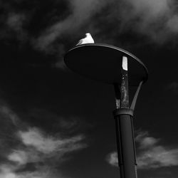 Low angle view of tower against cloudy sky