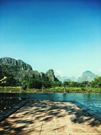 Scenic view of swimming pool against clear blue sky