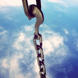 Metal structure against cloudy sky