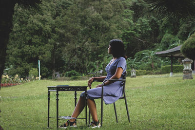 Full length of woman sitting on chair