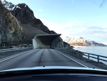 Car on road by mountain against sky