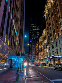 Street of manhattan, new york, at night, bright colors, lights and the full moon on display