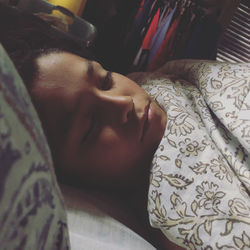 High angle view of man sleeping on bed at home