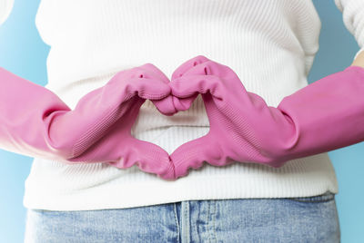 Close-up of woman holding pink flowers