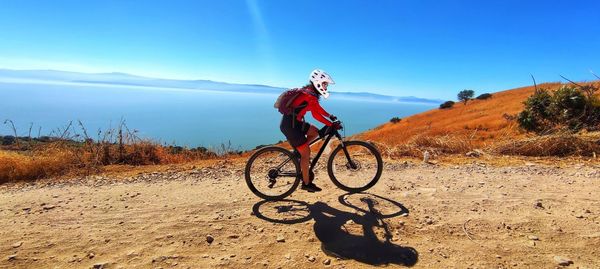 Woman riding bicycle on the mountains