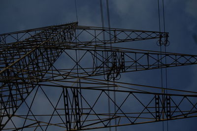 Close-up of silhouette electricity pylon against sky