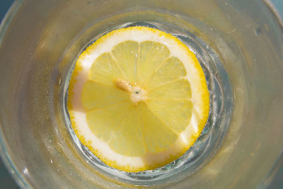 A fresh glass of lemonade with a lemon slice, summer drink