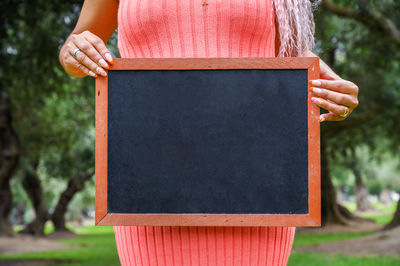 Midsection of woman holding box