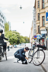 People riding bicycle on city street