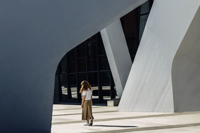 Portrait of woman standing in geometric modern architecture urban space