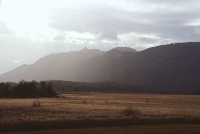 Scenic view of mountains against cloudy sky