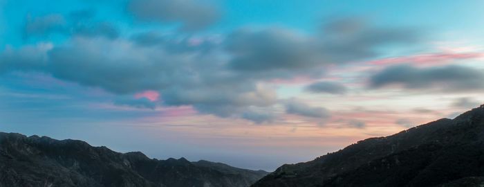 Low angle view of mountains against dramatic sky