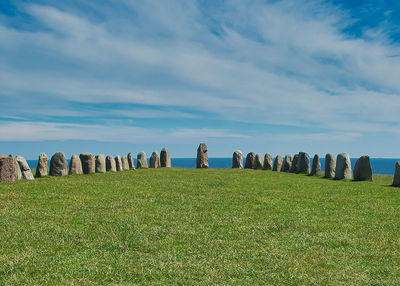 Viking monument on field against sky