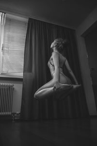 Woman levitating at home
