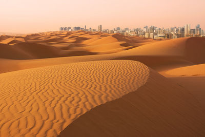 Sand dune in desert against sky