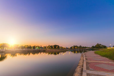 Scenic view of lake against blue sky during sunset