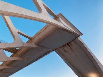 Low angle view of bridge against clear blue sky