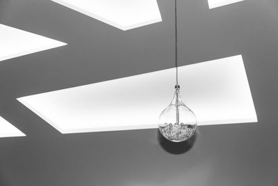 Low angle view of illuminated pendant lights hanging from ceiling