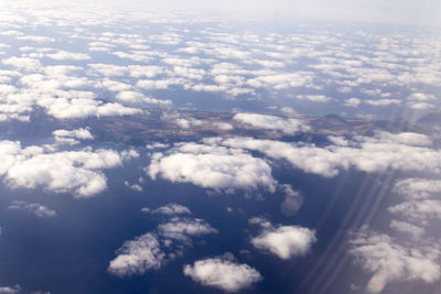 Aerial view of landscape against cloudy sky