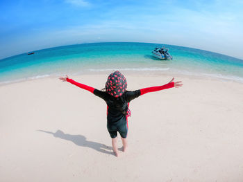 Full length of woman walking on beach