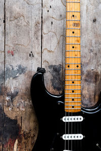 Close-up of guitar against wall