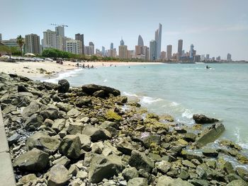 Panoramic view of sea and buildings against sky