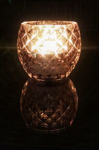 Close-up of illuminated lamp against black background