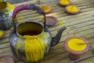 Beeswax kettle and lamp was placed in bamboo bench for use as a candle casting .