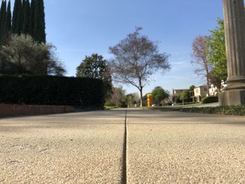 Surface level of road against blue sky