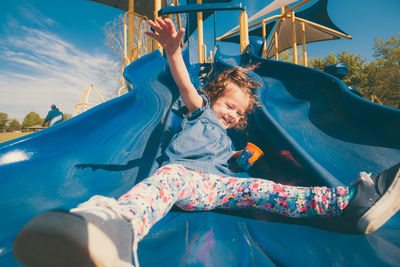 Low angle view of children playing at playground