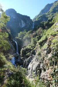 Scenic view of river amidst mountains against clear sky