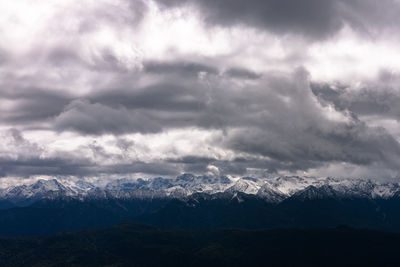 Low angle view of snowcapped mountains against sky