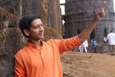 Man looking away while standing against fort