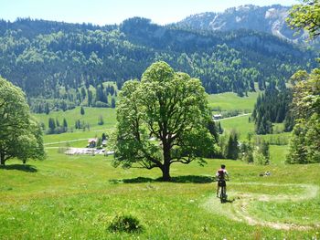 Man on golf course against sky