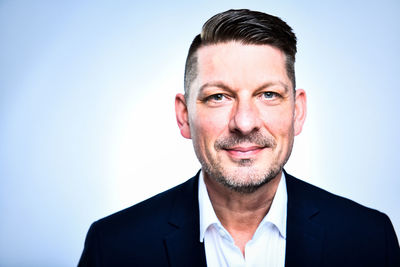 Portrait of smiling man against gray background