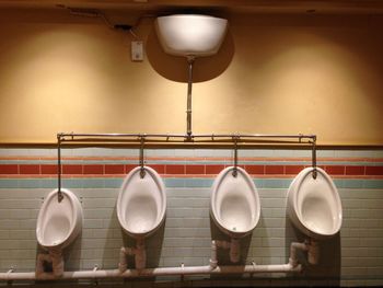 Row of urinals at public restroom