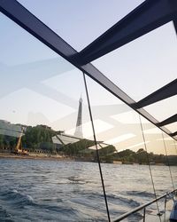 Sailboat by sea against clear sky