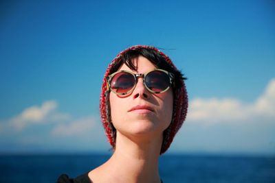 Portrait of woman wearing sunglasses against sky